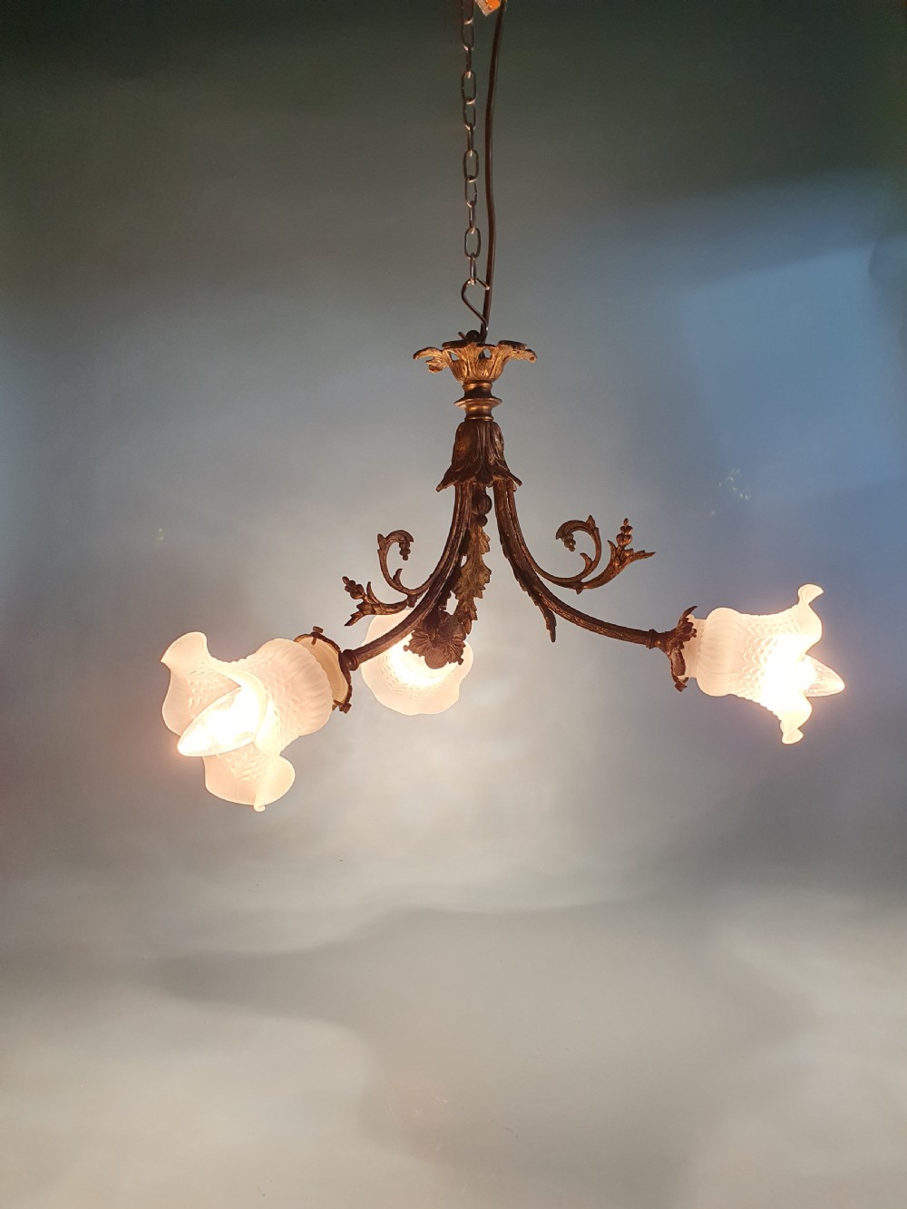 Early 20th century guilt brass chandelier with three glass shades View IV