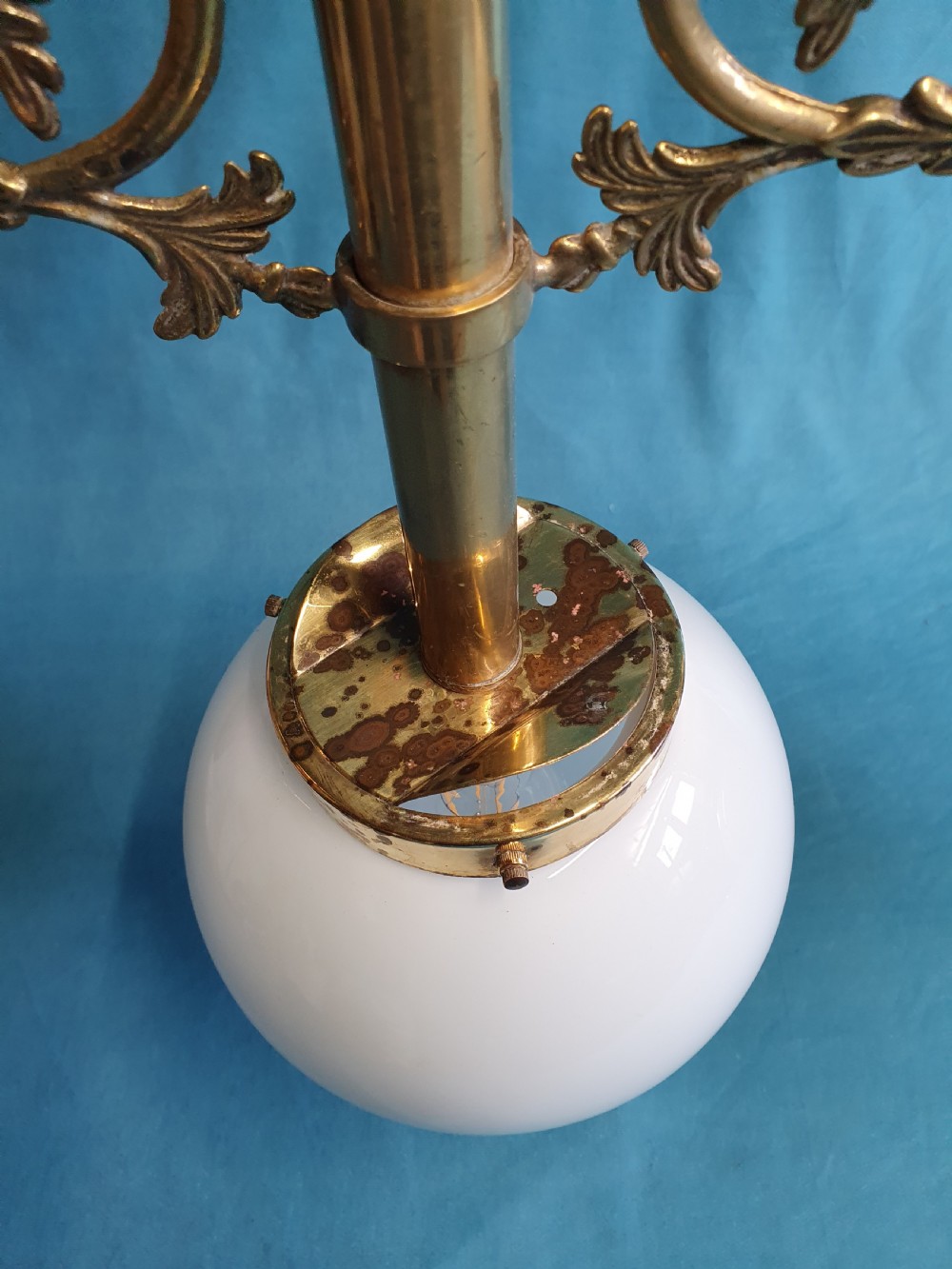 An early 20th-century Gothic Revival linear brass chandelier featuring a horizontal bar structure with ornate scrollwork brackets and two suspended white opaline glass globes. View III