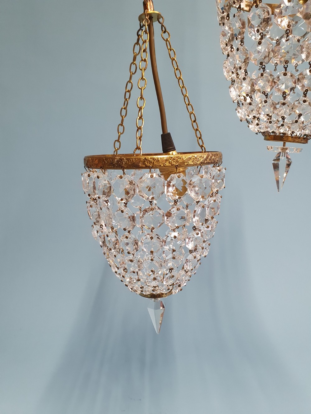 A pair of small early 20th-century bag chandeliers featuring brass rims decorated with linked glass crystal beads and lower teardrop prisms. View III