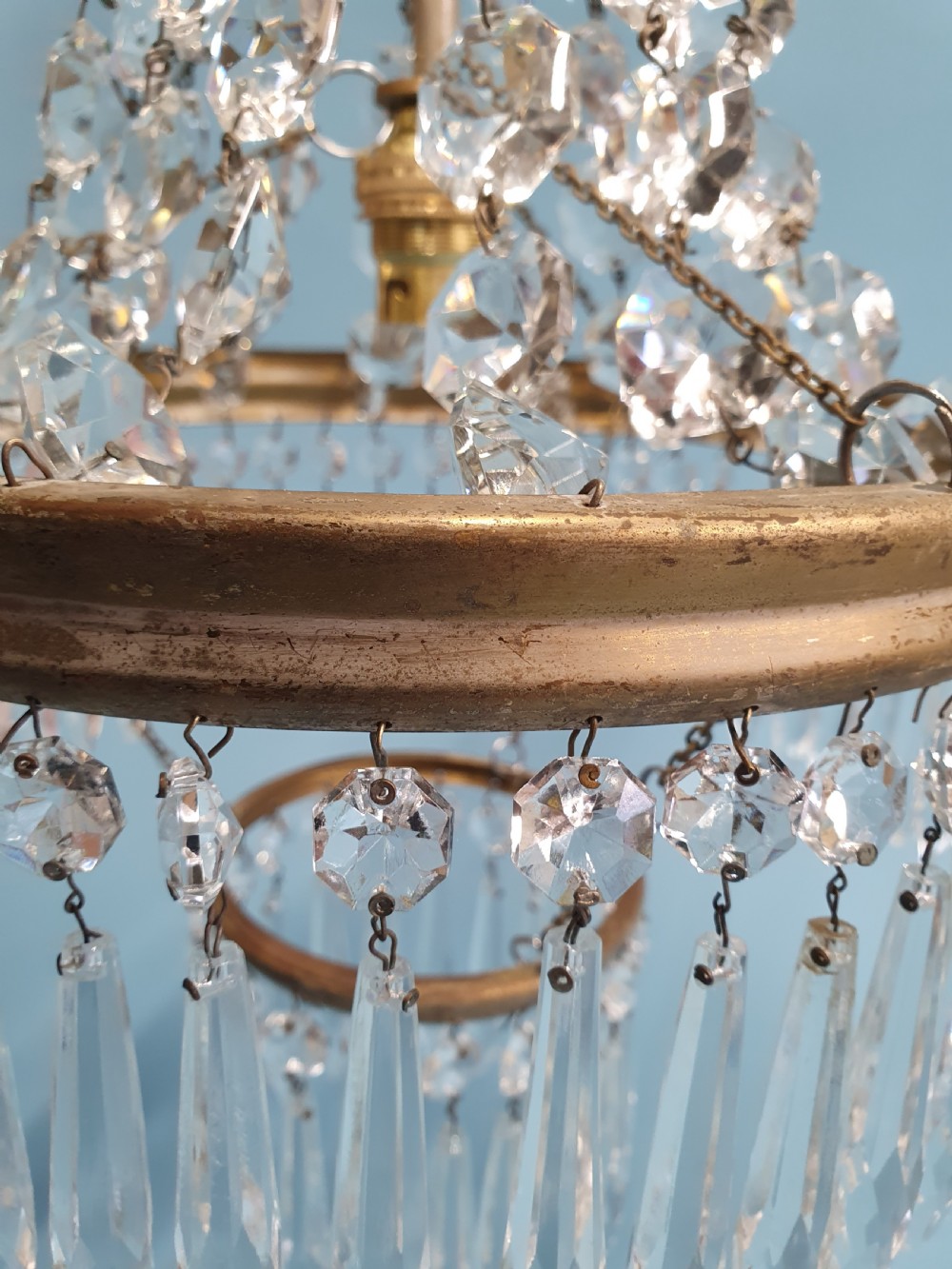 An early 20th-century ceiling chandelier featuring a tent of cascading crystal beads ending at a brass ring hung with vertical crystal spike drops. View III