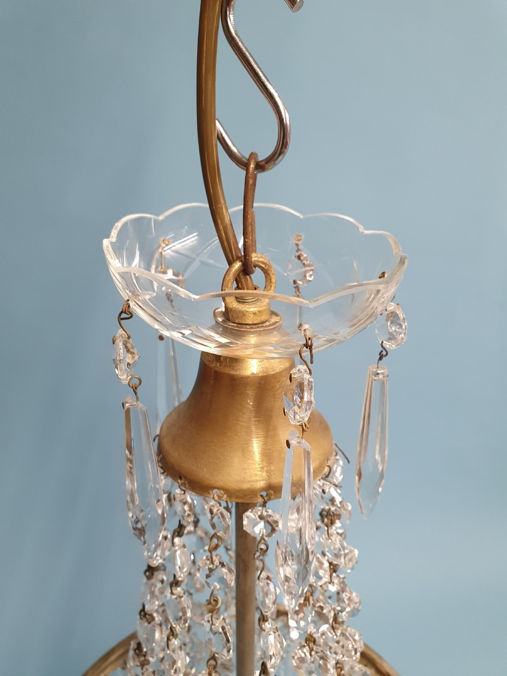 An early 20th-century ceiling chandelier featuring a tent of cascading crystal beads ending at a brass ring hung with vertical crystal spike drops. View VIII