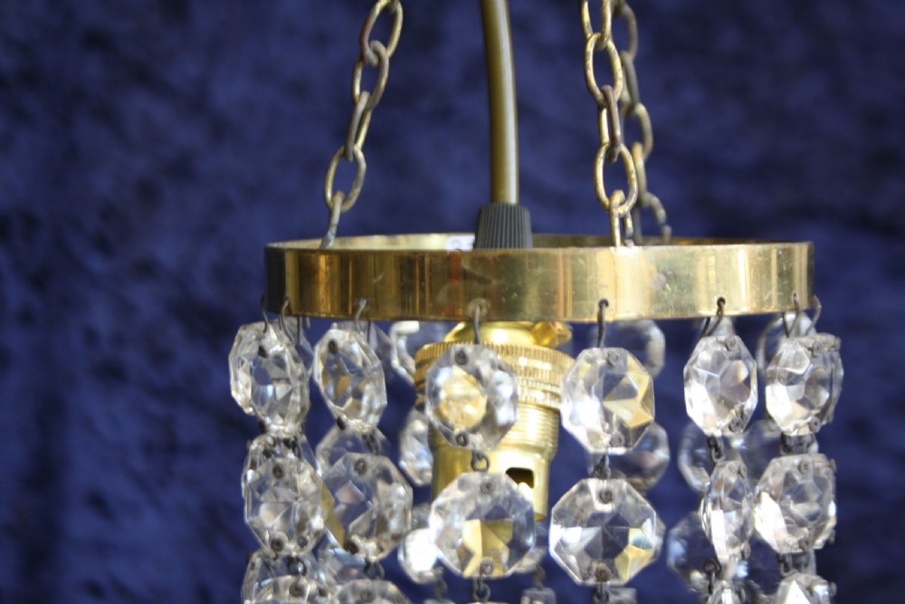 A pair of early 20th-century brass pendant chandeliers adorned with circular glass beads and pointed crystal spike drops. View III