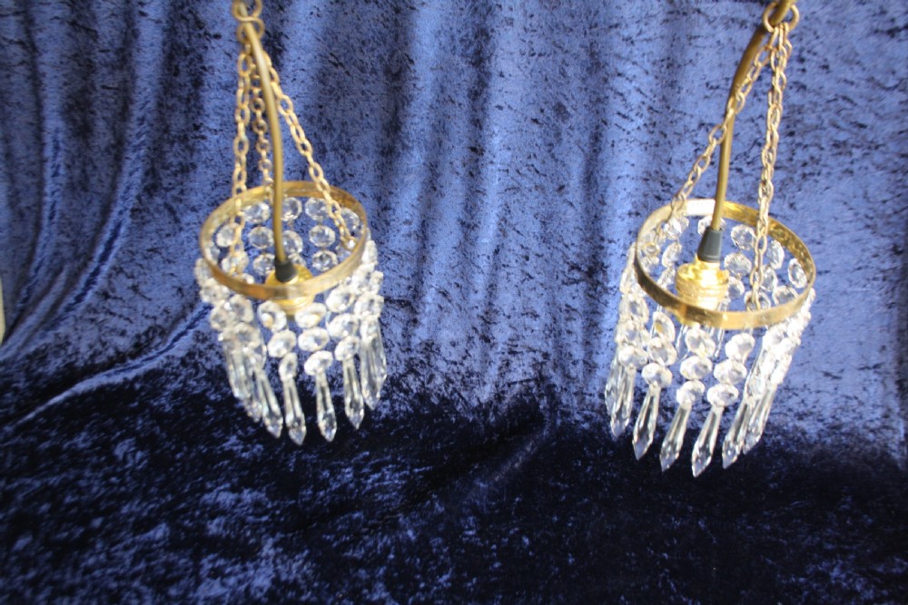 A pair of early 20th-century brass pendant chandeliers adorned with circular glass beads and pointed crystal spike drops. View IV