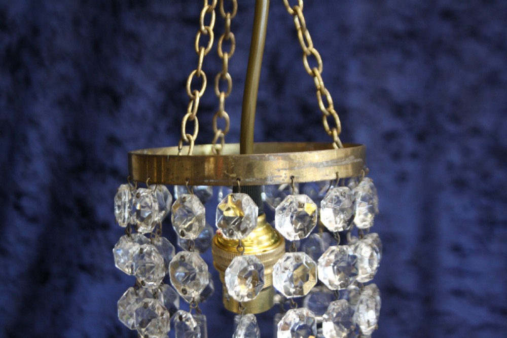 A pair of early 20th-century brass pendant chandeliers adorned with circular glass beads and pointed crystal spike drops. View VII