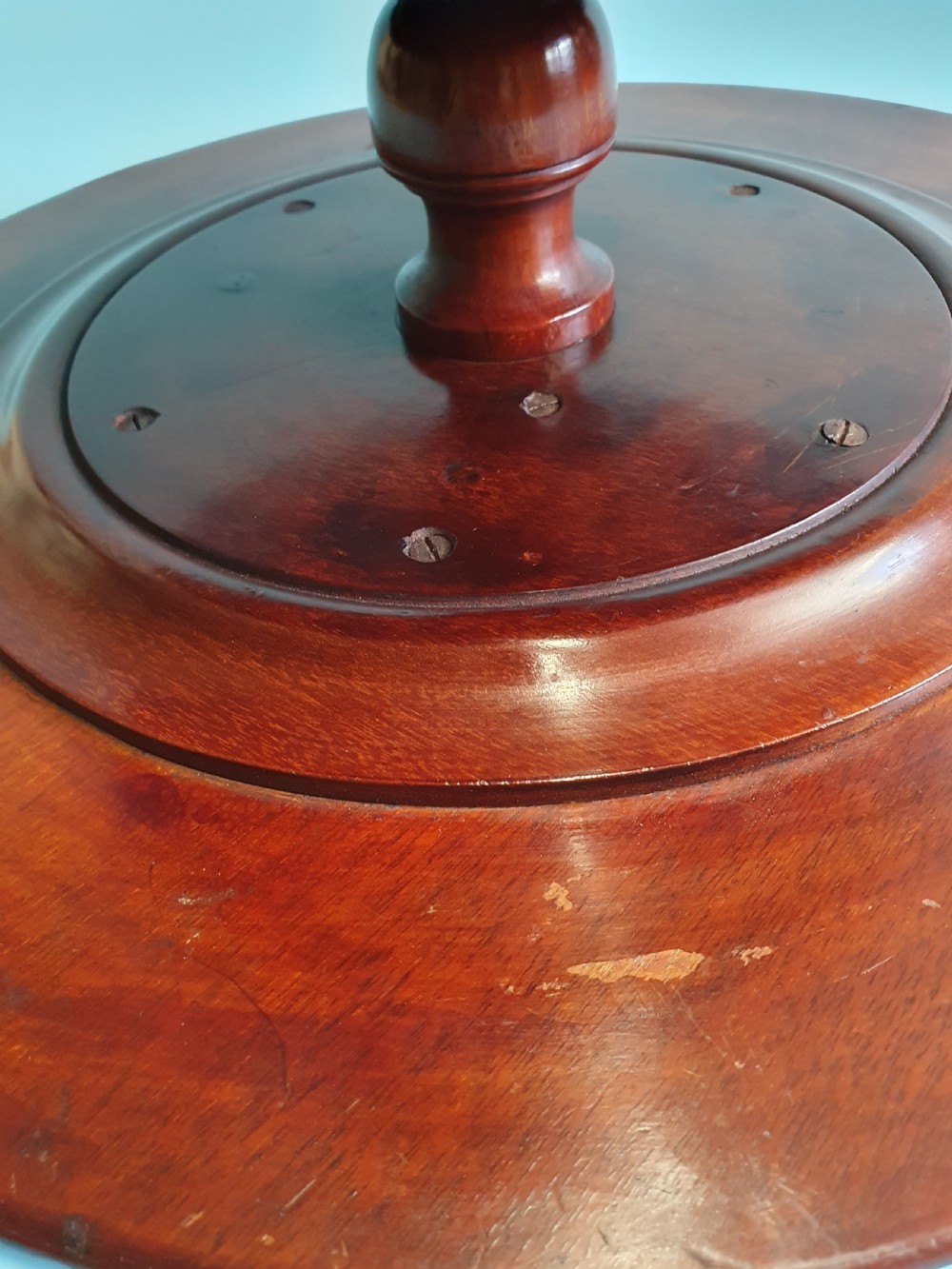 A circular Edwardian mahogany lazy Susan with a raised moulded edge resting on a central turned pedestal base. View IV