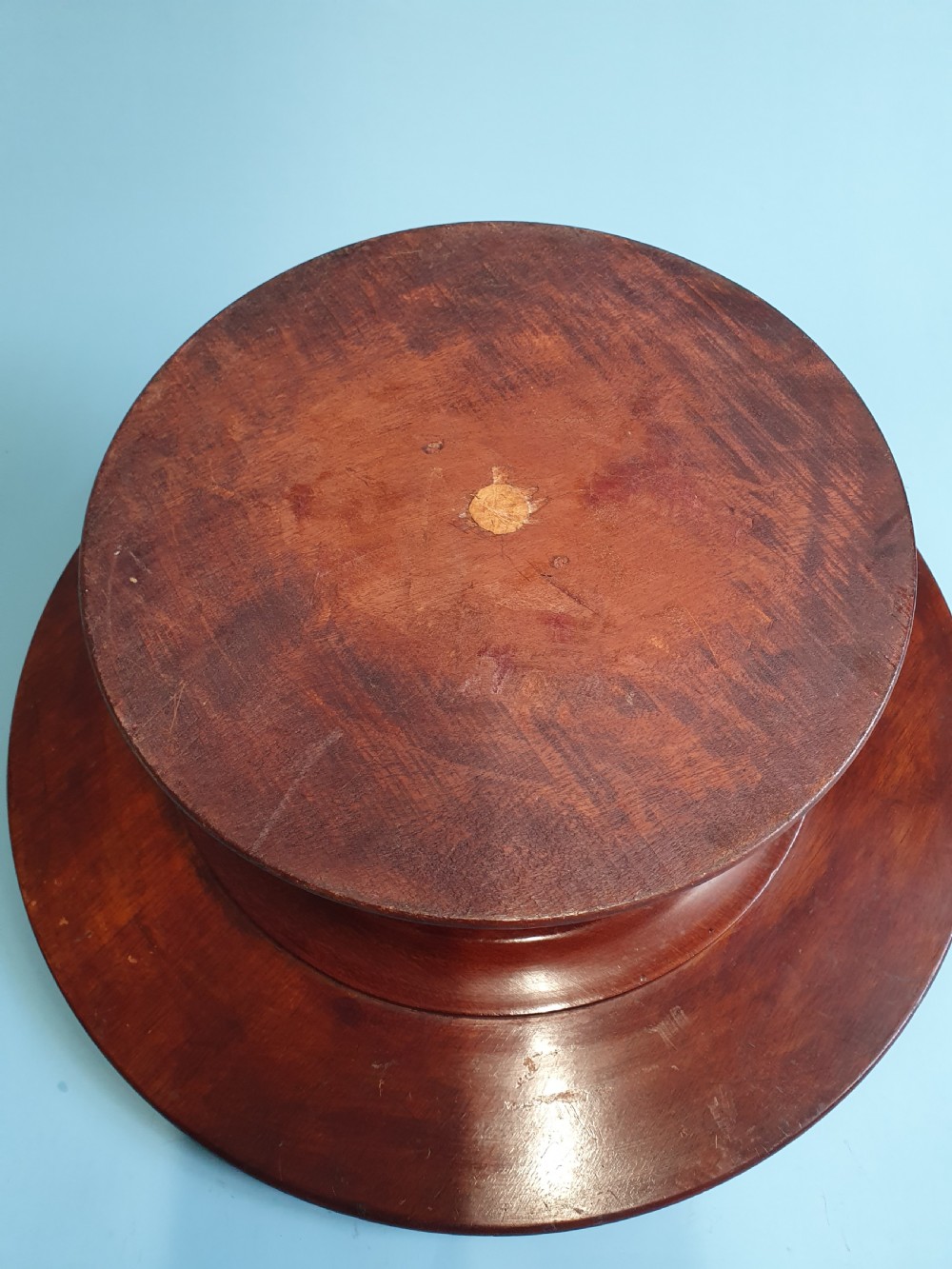 A circular Edwardian mahogany lazy Susan with a raised moulded edge resting on a central turned pedestal base. View V