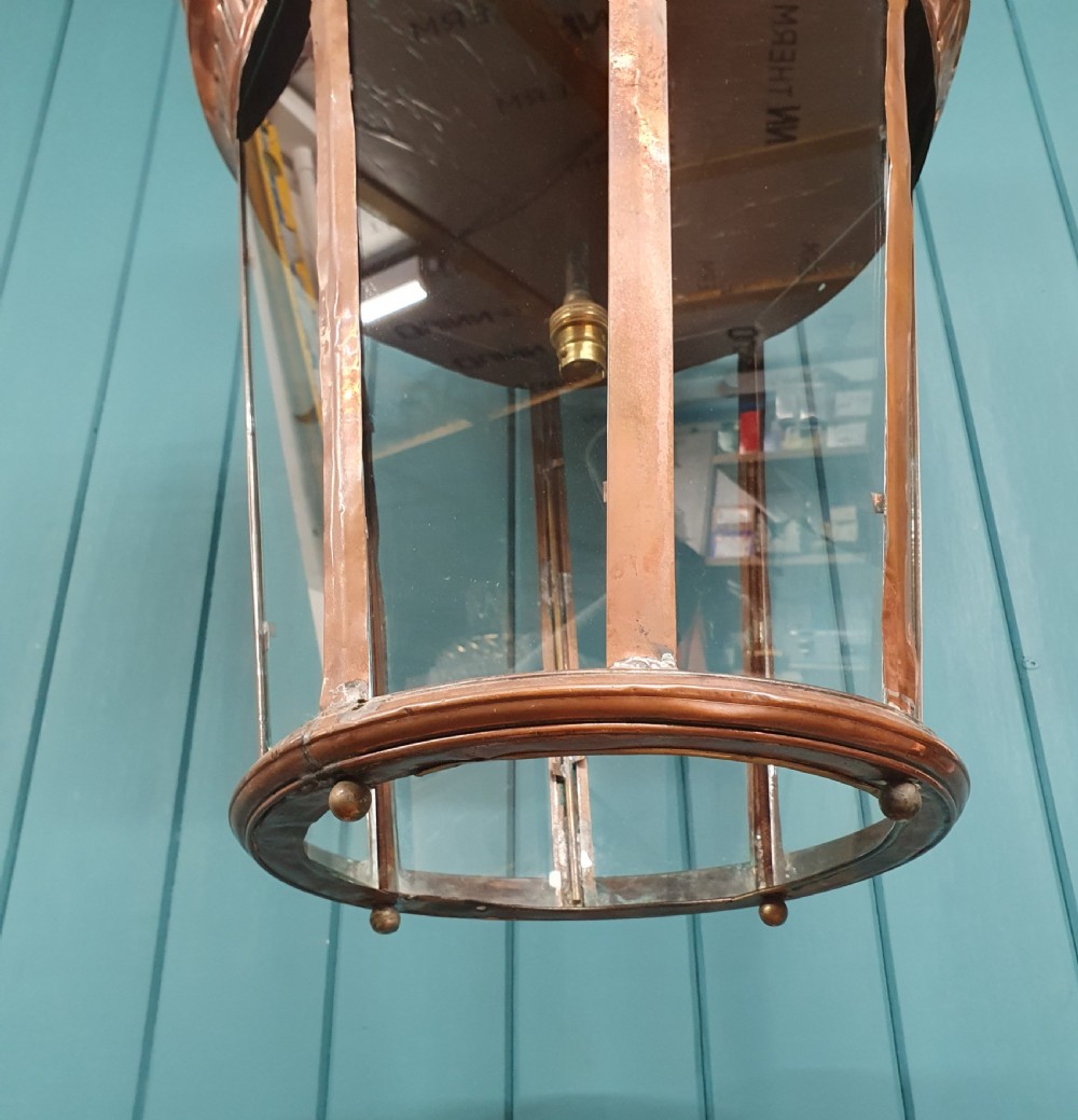 A large circular antique copper lantern with clear glass panels, decorative pierced gallery trim, and suspension chain. View II