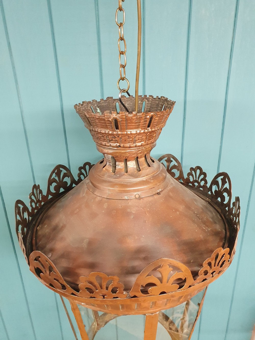 A large circular antique copper lantern with clear glass panels, decorative pierced gallery trim, and suspension chain. View III