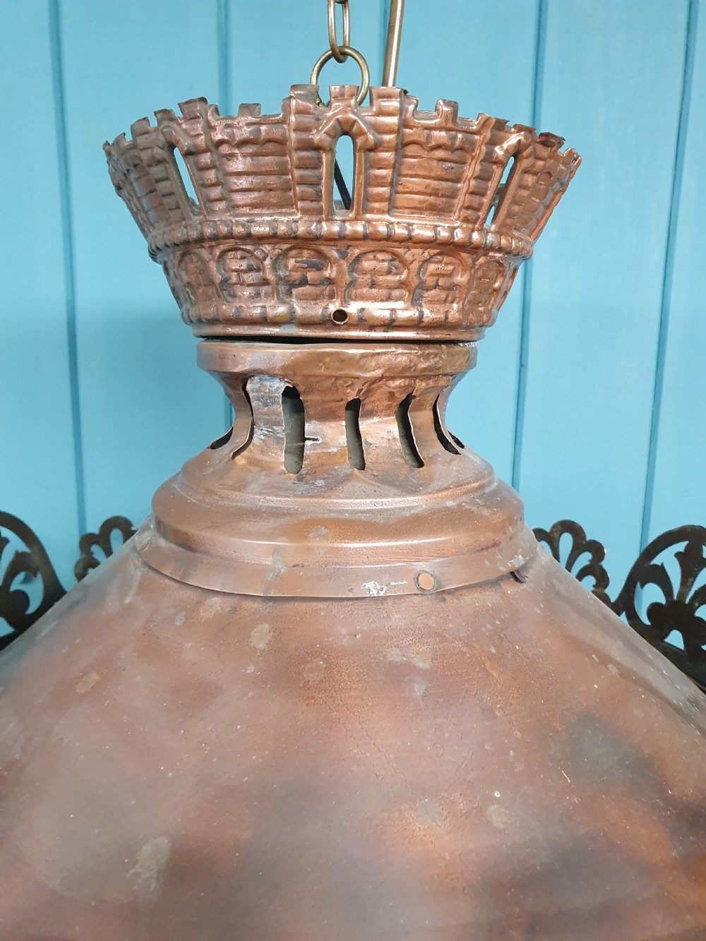A large circular antique copper lantern with clear glass panels, decorative pierced gallery trim, and suspension chain. View VI