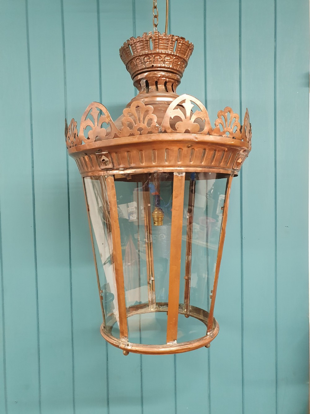 A large circular antique copper lantern with clear glass panels, decorative pierced gallery trim, and suspension chain. View VII