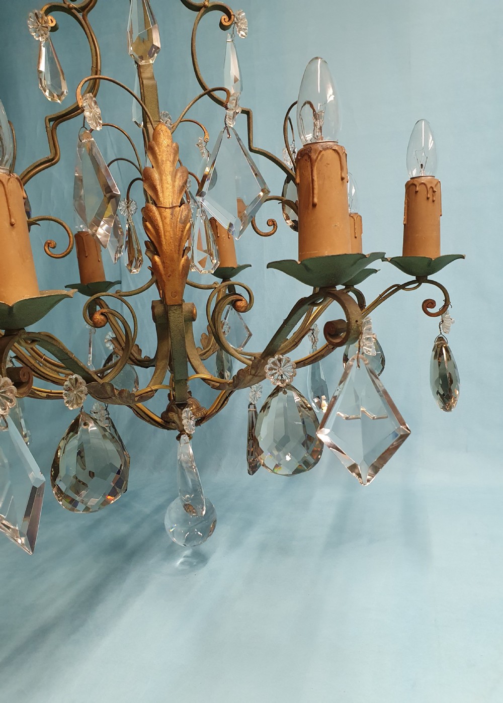 An early twentieth-century French green steel six-light chandelier adorned with faceted crystal glass drops and pleated white fabric shades. View II