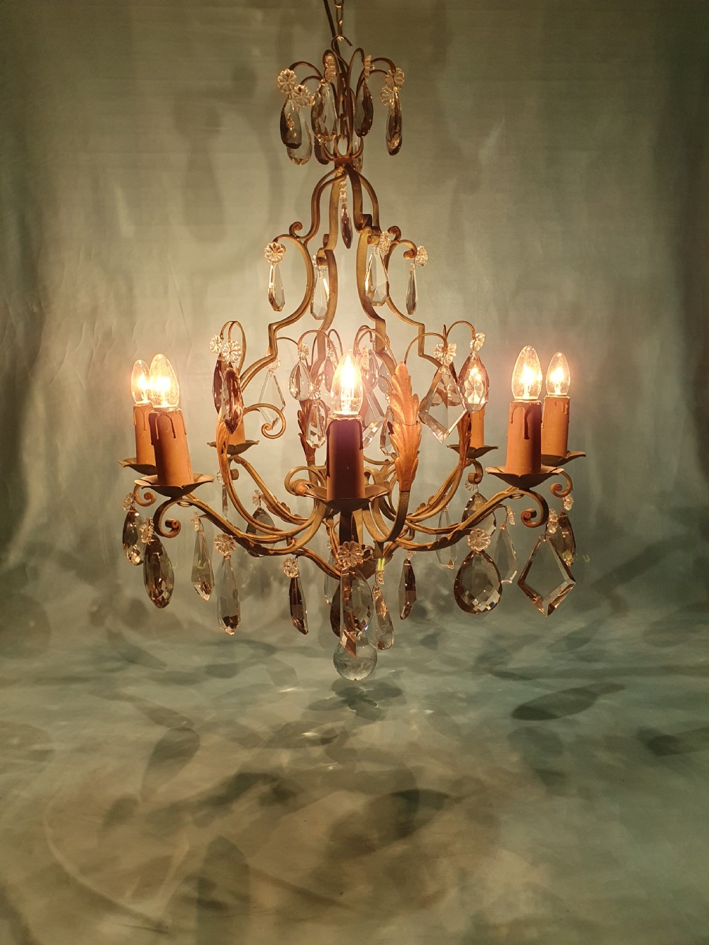 An early twentieth-century French green steel six-light chandelier adorned with faceted crystal glass drops and pleated white fabric shades. View III