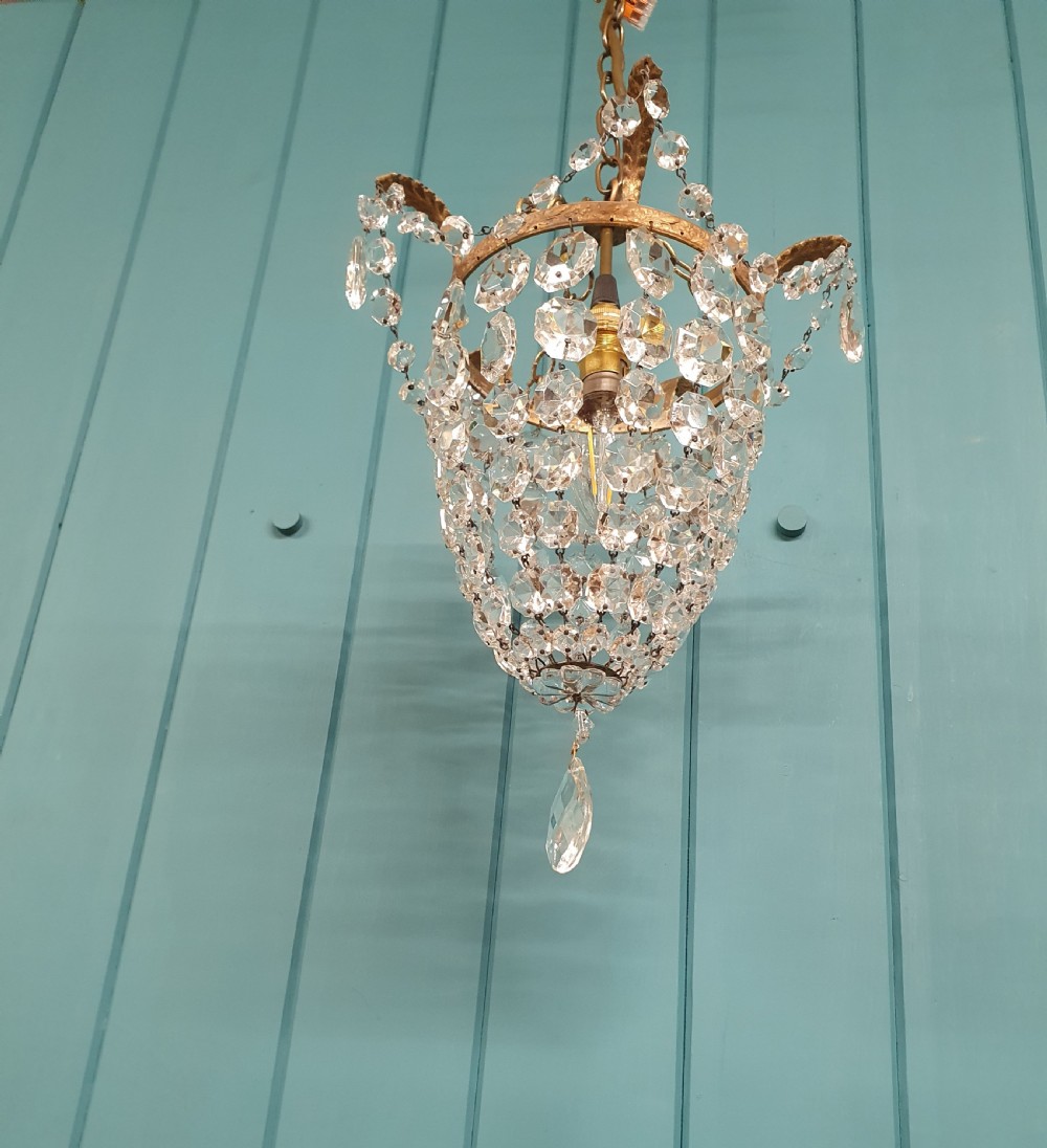 A small early 20th-century ceiling pendant featuring a brass frame hung with faceted clear glass crystal beads formed into a tapered basket shape. View III