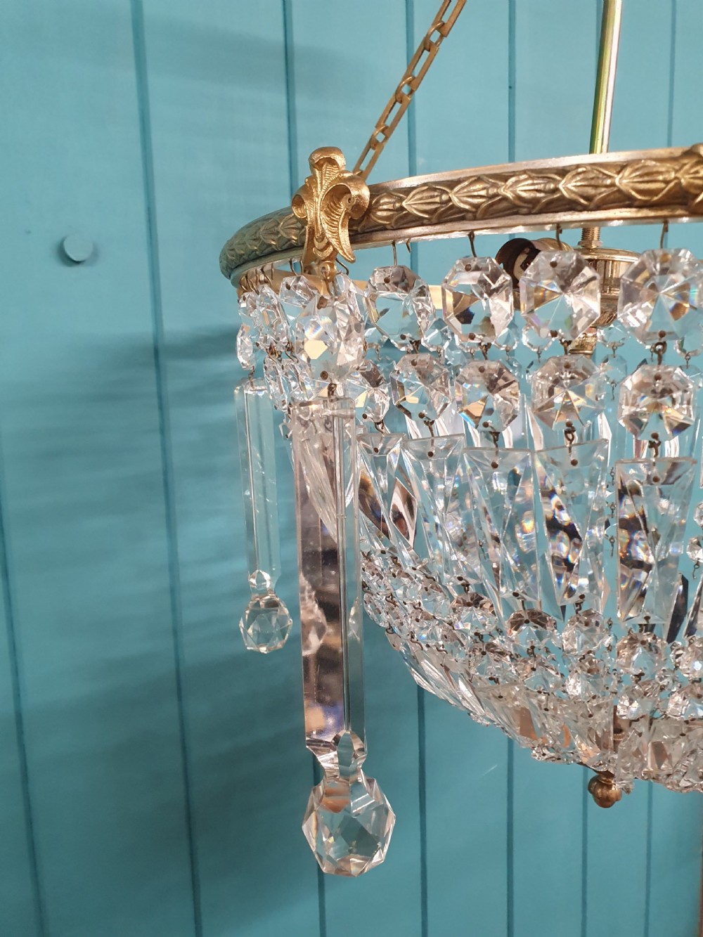 An early twentieth-century brass and cut glass bag basket chandelier with long rectangular prisms and hanging faceted glass drops. View III