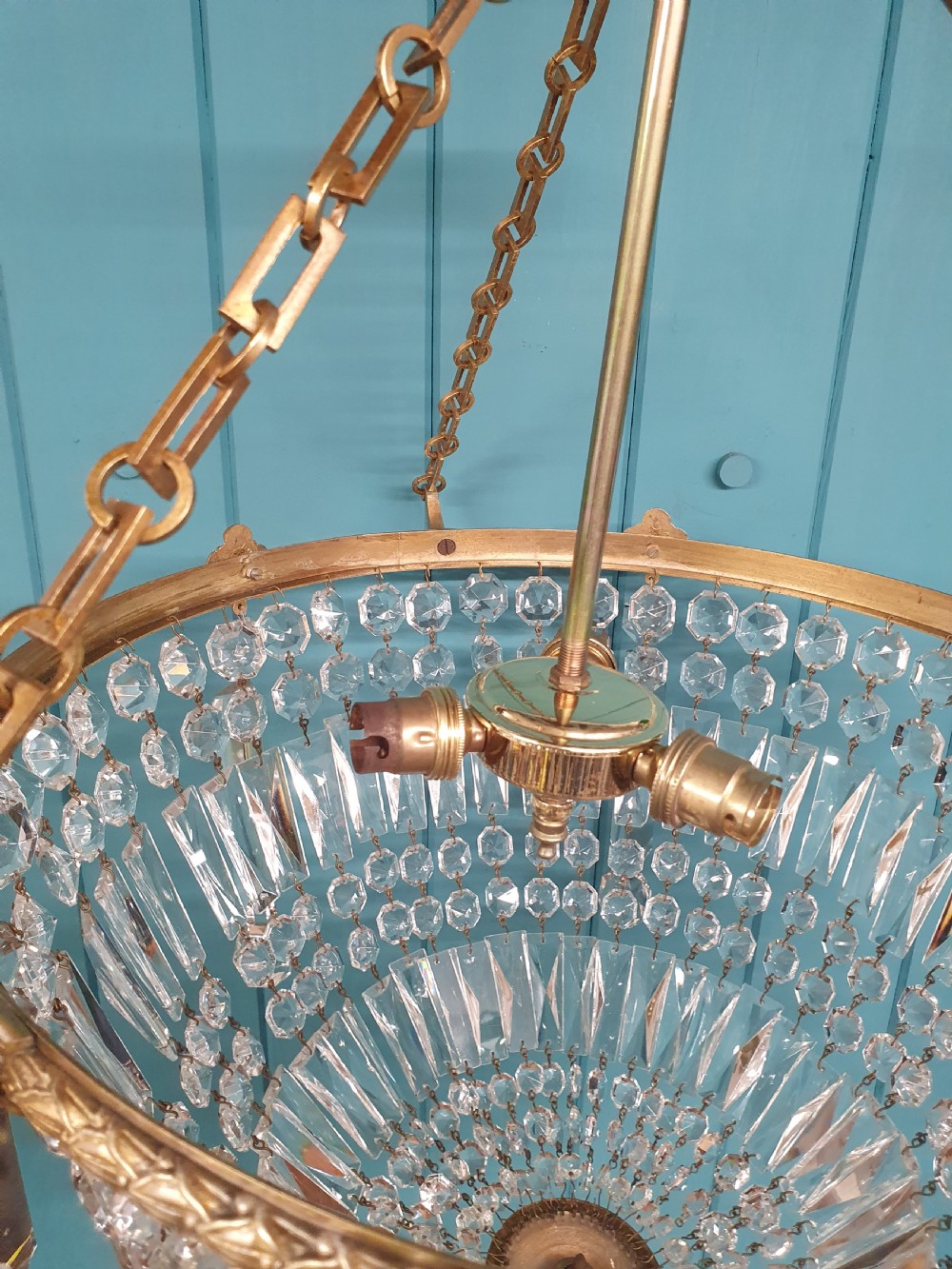 An early twentieth-century brass and cut glass bag basket chandelier with long rectangular prisms and hanging faceted glass drops. View VI