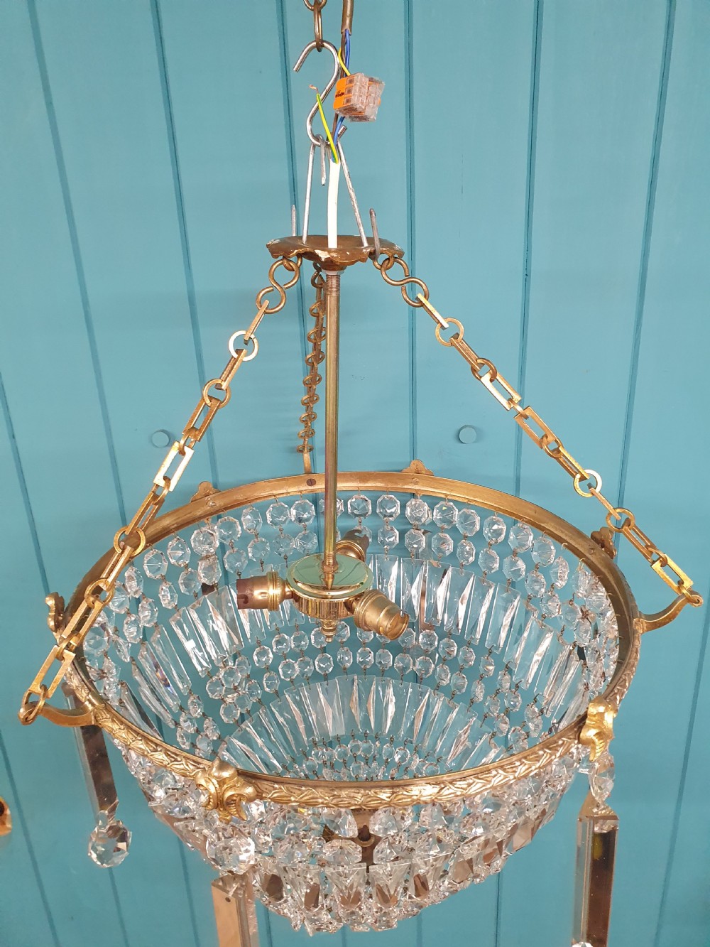 An early twentieth-century brass and cut glass bag basket chandelier with long rectangular prisms and hanging faceted glass drops. View VII