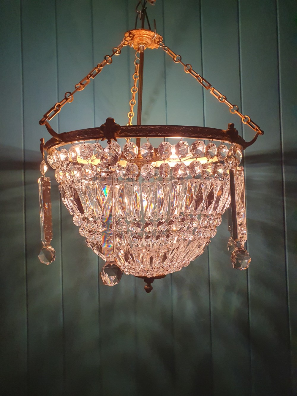An early twentieth-century brass and cut glass bag basket chandelier with long rectangular prisms and hanging faceted glass drops. View VIII