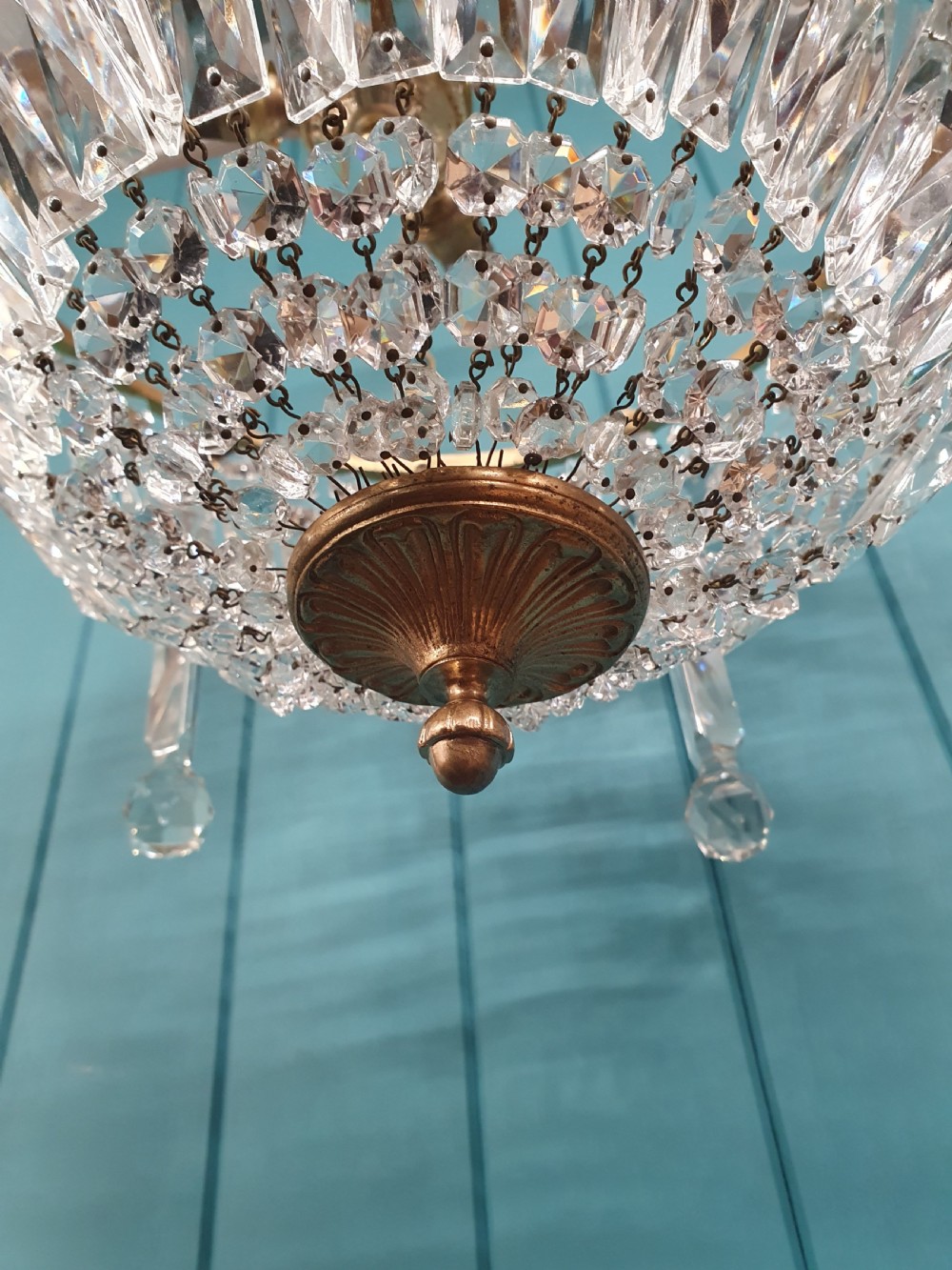 An early twentieth-century brass and cut glass bag basket chandelier with long rectangular prisms and hanging faceted glass drops. View IX