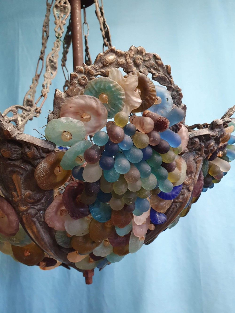 An early 20th-century Continental ceiling chandelier featuring a brass frame decorated with colourful opaque glass grapes and flowers. View II