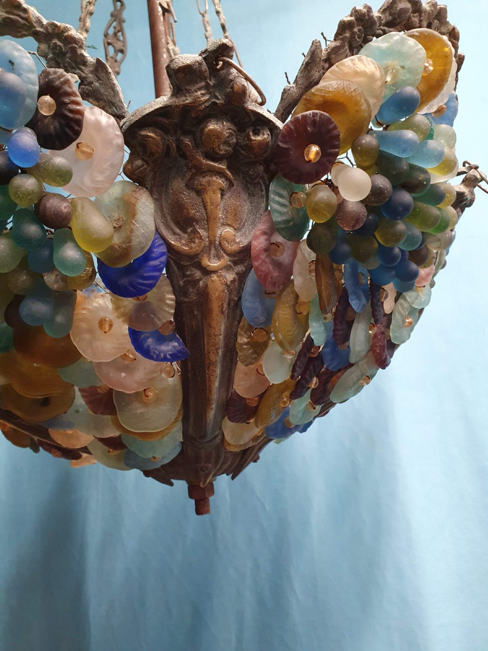 An early 20th-century Continental ceiling chandelier featuring a brass frame decorated with colourful opaque glass grapes and flowers. View VI