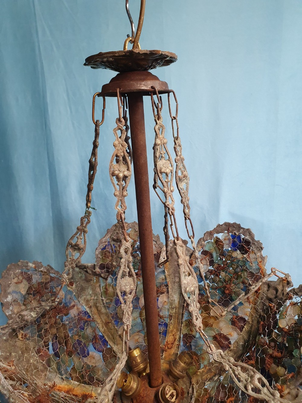 An early 20th-century Continental ceiling chandelier featuring a brass frame decorated with colourful opaque glass grapes and flowers. View VII