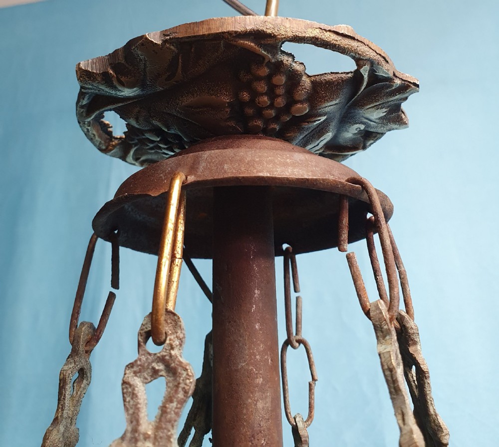 An early 20th-century Continental ceiling chandelier featuring a brass frame decorated with colourful opaque glass grapes and flowers. View VIII