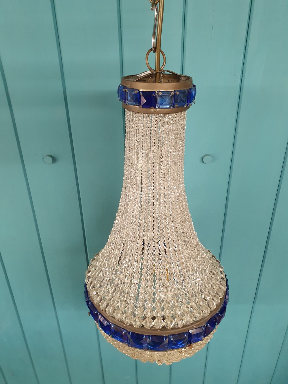 An early 20th-century beaded crystal basket chandelier featuring decorative bands of square-cut cobalt blue glass prisms and a brass frame. View III