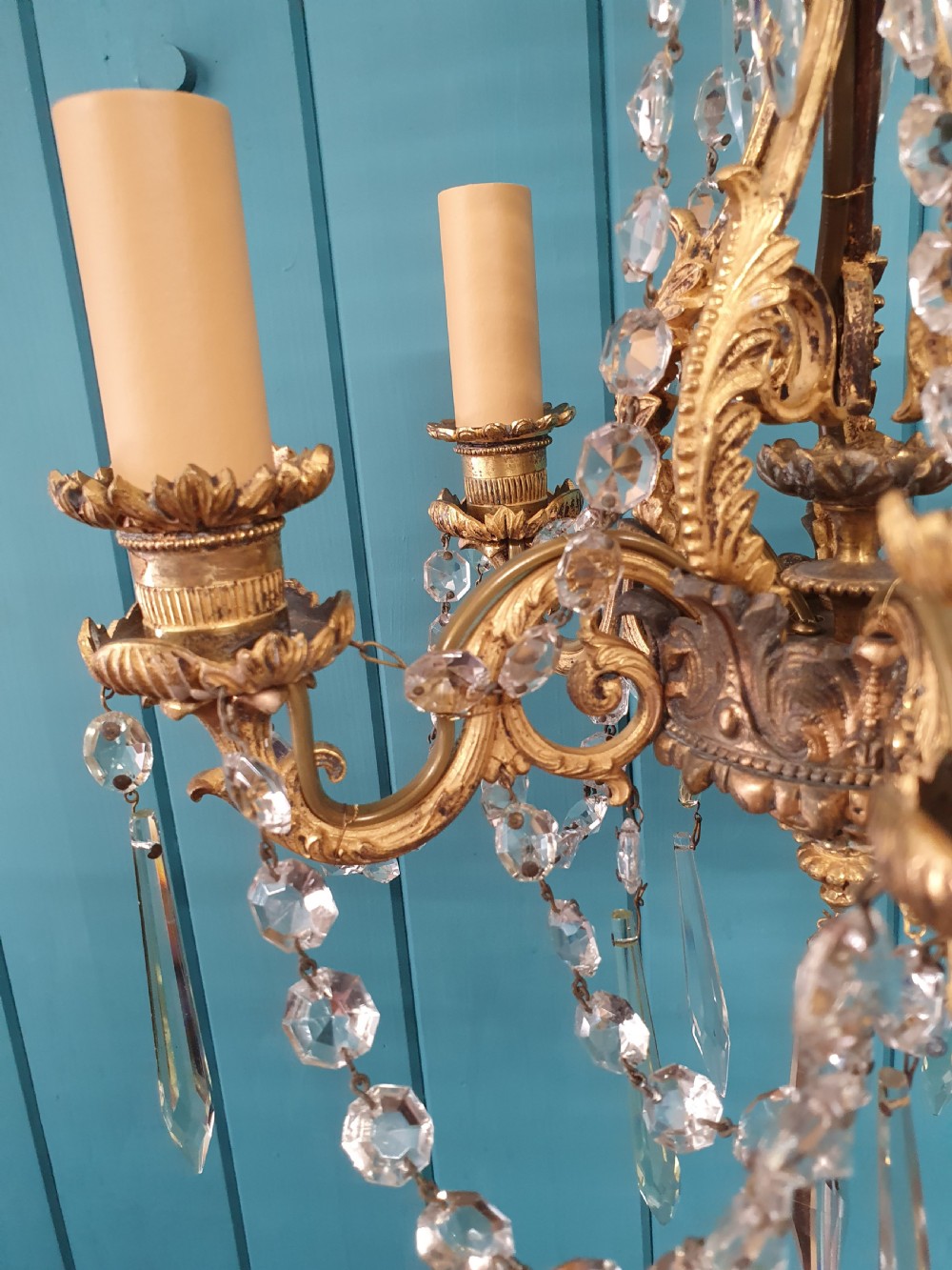 An early 20th-century small gilt brass five-arm chandelier decorated with clear glass crystal swags and teardrop pendants. View III
