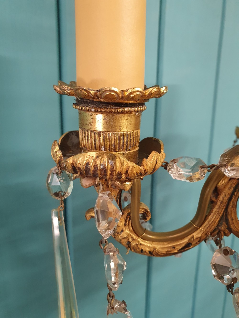 An early 20th-century small gilt brass five-arm chandelier decorated with clear glass crystal swags and teardrop pendants. View VIII