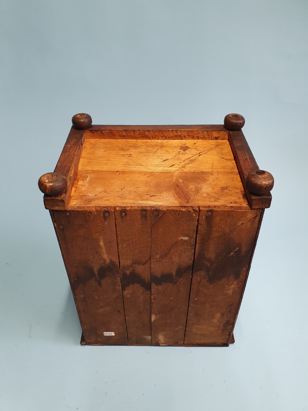 An early nineteenth-century miniature pine chest featuring two short drawers above two long drawers with turned wooden knobs and bun feet. View VII
