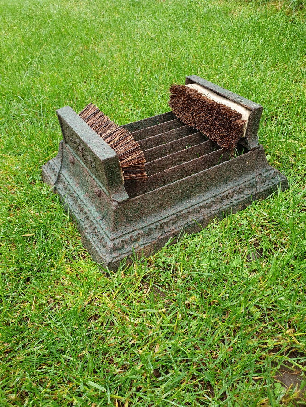 Late 19 century cast iron boot scraper with brushes to the side