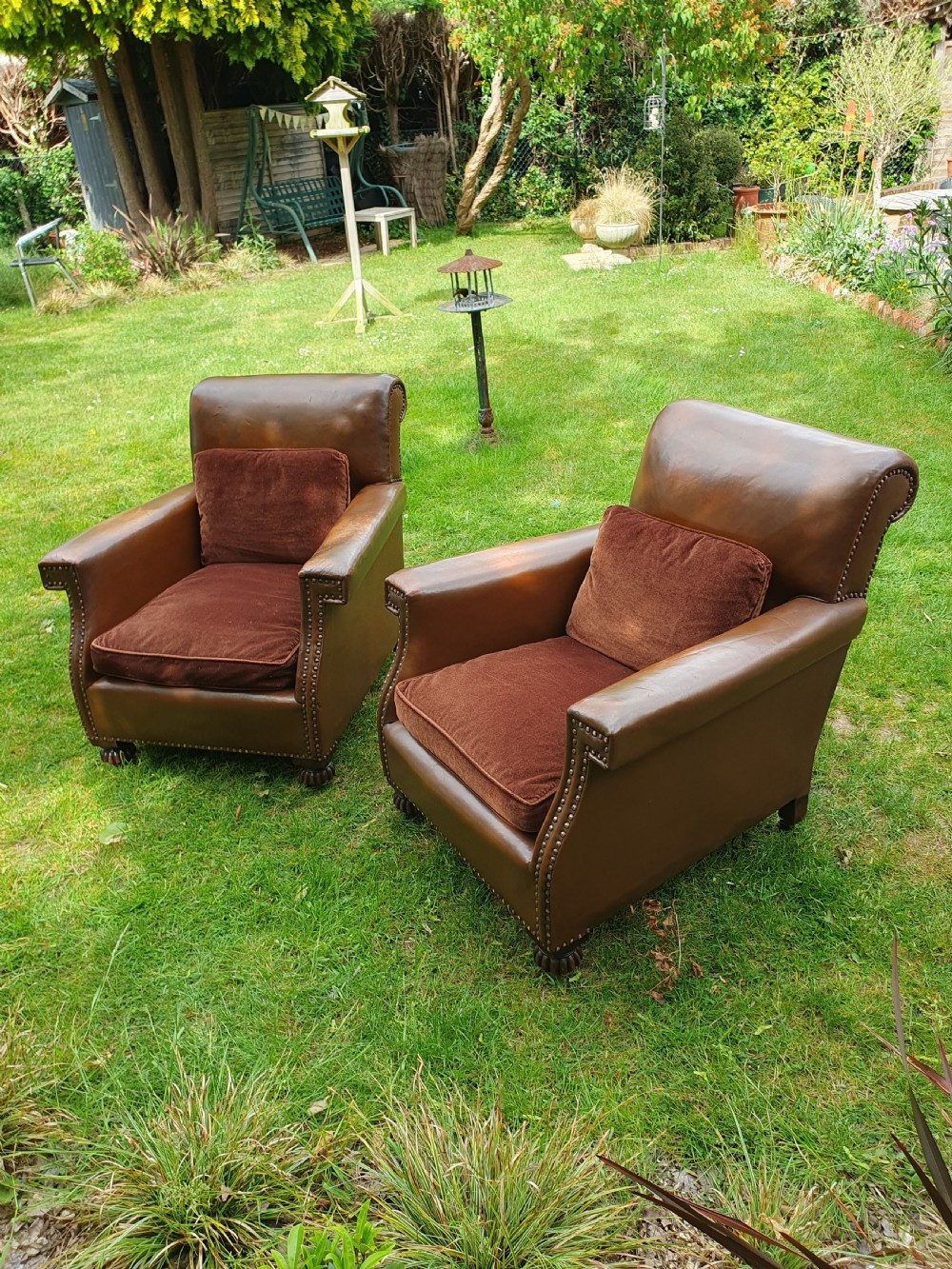 Early 20th century pair of chocolate brown leather chairs