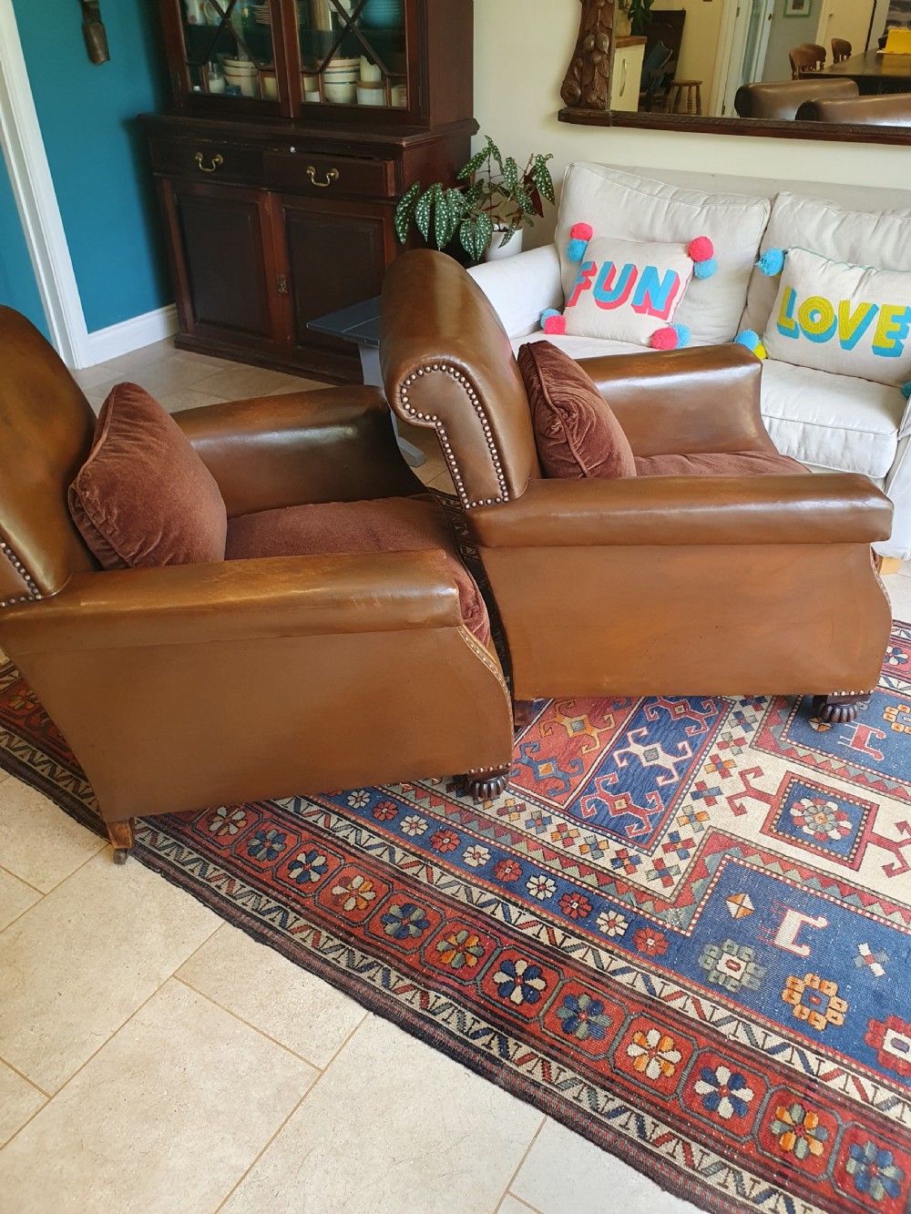 Early 20th century pair of chocolate brown leather chairs View II