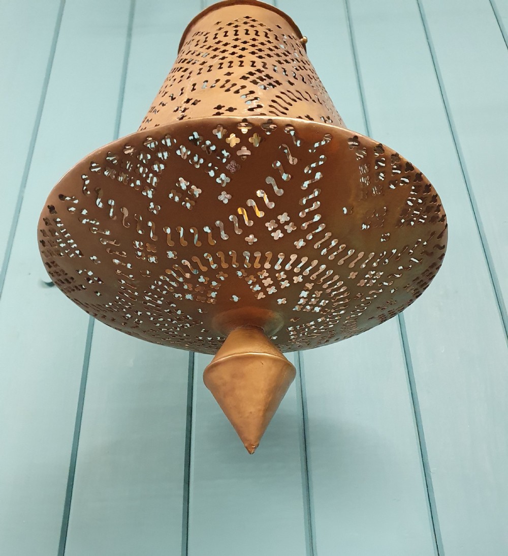 A flared bell-shaped pierced brass pendant light with geometric reticulated patterns suspended from a brass chain. View VI