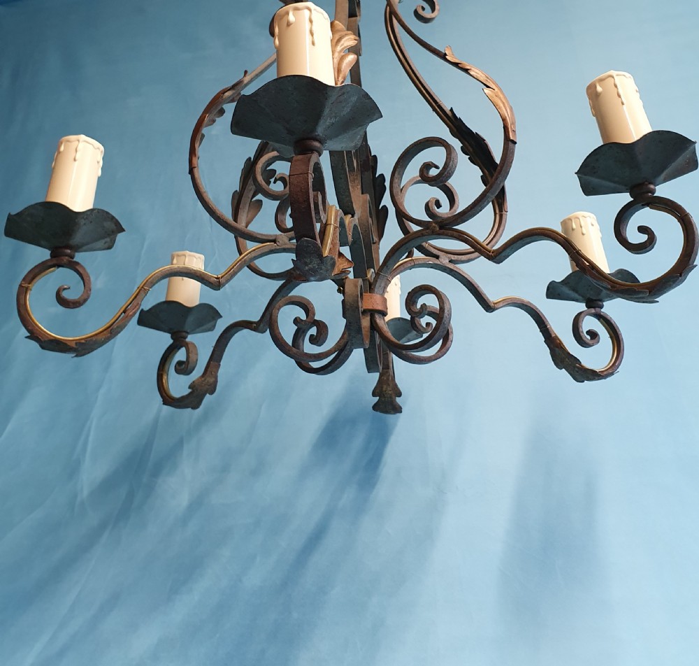 A dark green six-arm wrought steel chandelier with scrollwork arms, candle sleeves, and dark lampshades. View VII