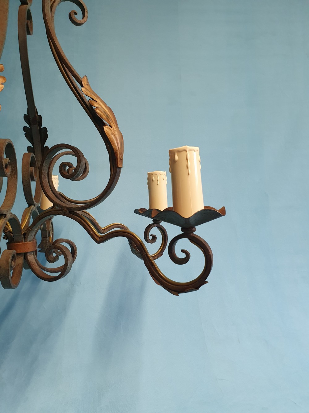 A dark green six-arm wrought steel chandelier with scrollwork arms, candle sleeves, and dark lampshades. View VIII