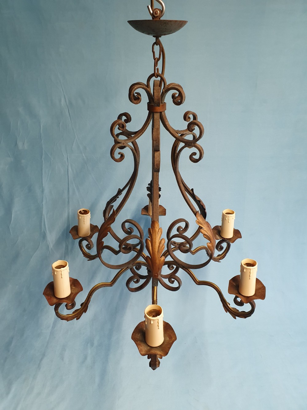 A dark green six-arm wrought steel chandelier with scrollwork arms, candle sleeves, and dark lampshades. View X