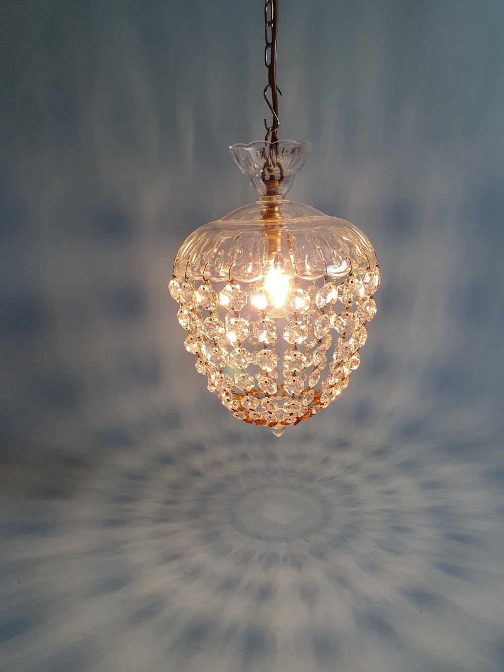 A small ceiling light with a clear glass dome top and cascading strands of faceted glass beads forming a tapered pendant shape. View II