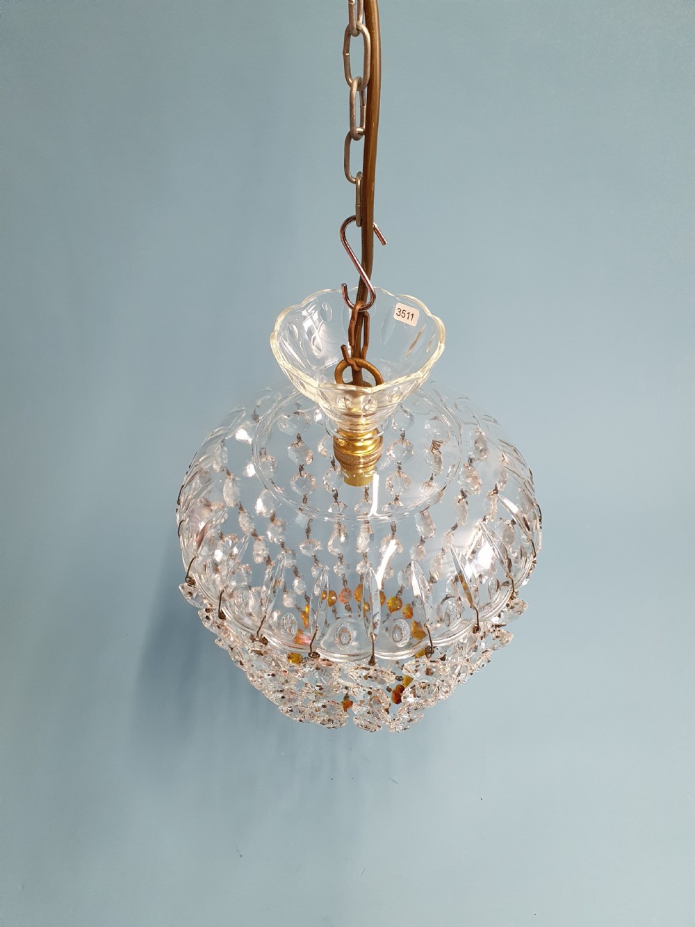 A small ceiling light with a clear glass dome top and cascading strands of faceted glass beads forming a tapered pendant shape. View III