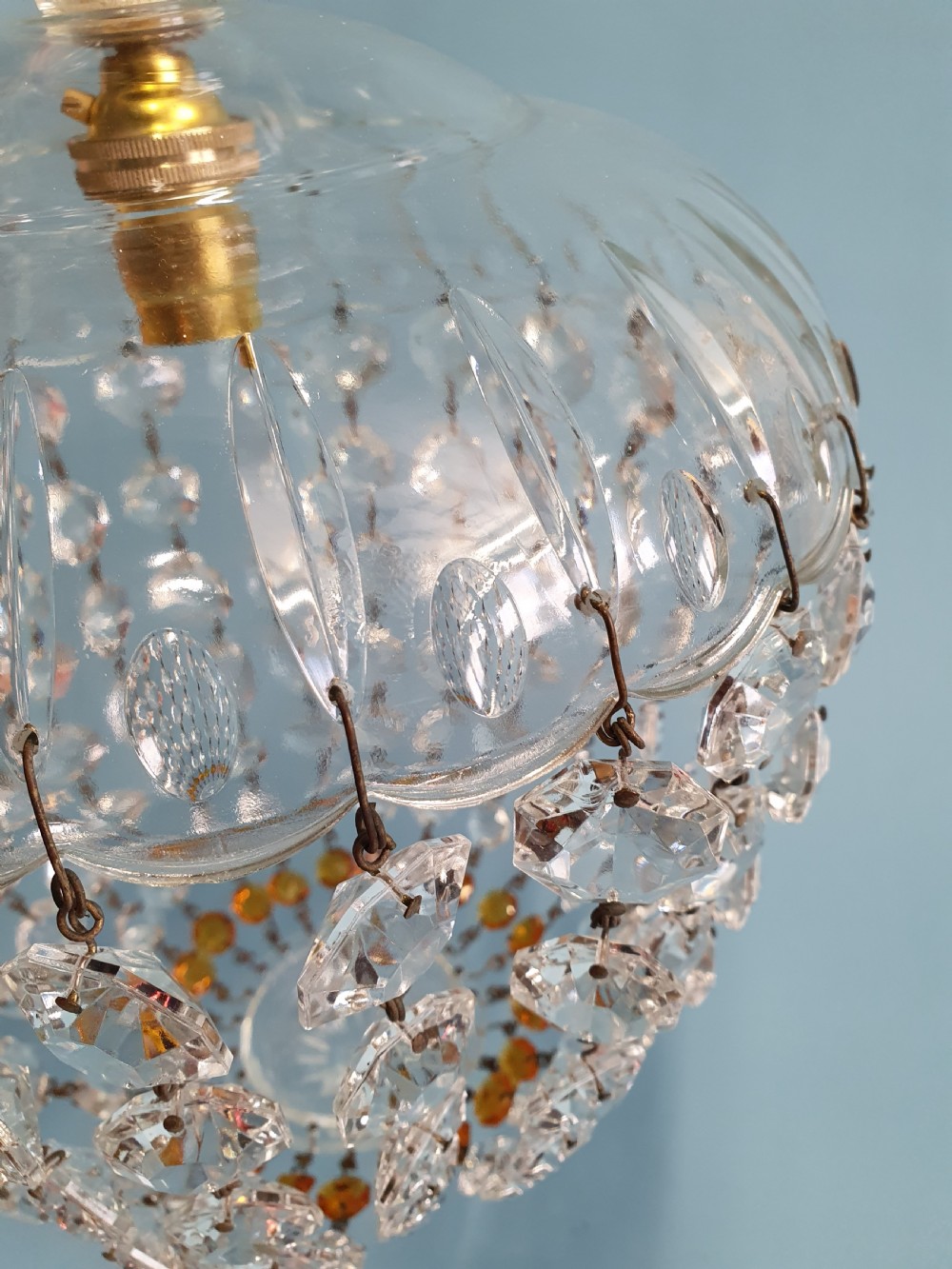 A small ceiling light with a clear glass dome top and cascading strands of faceted glass beads forming a tapered pendant shape. View IV