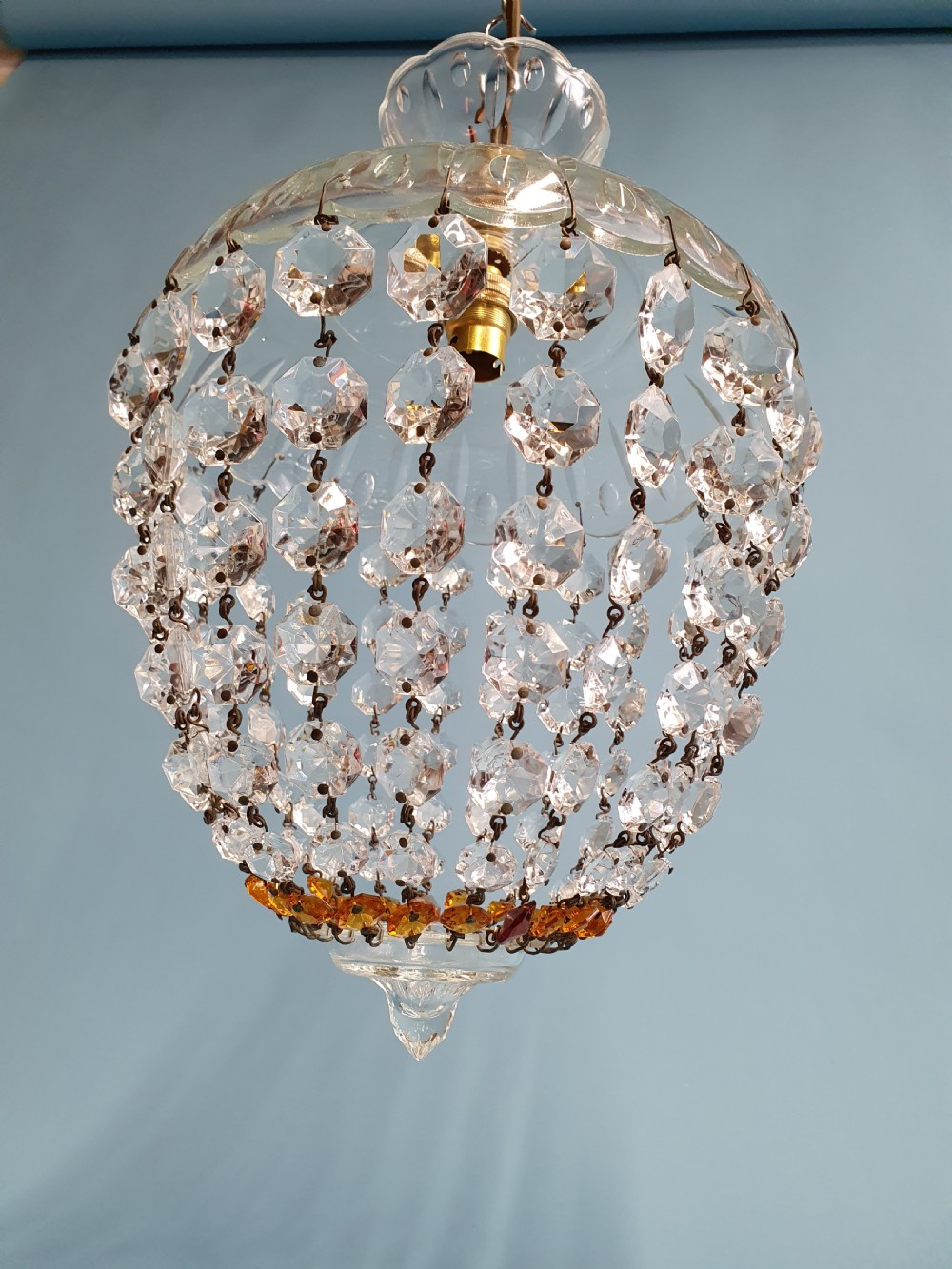 A small ceiling light with a clear glass dome top and cascading strands of faceted glass beads forming a tapered pendant shape. View V