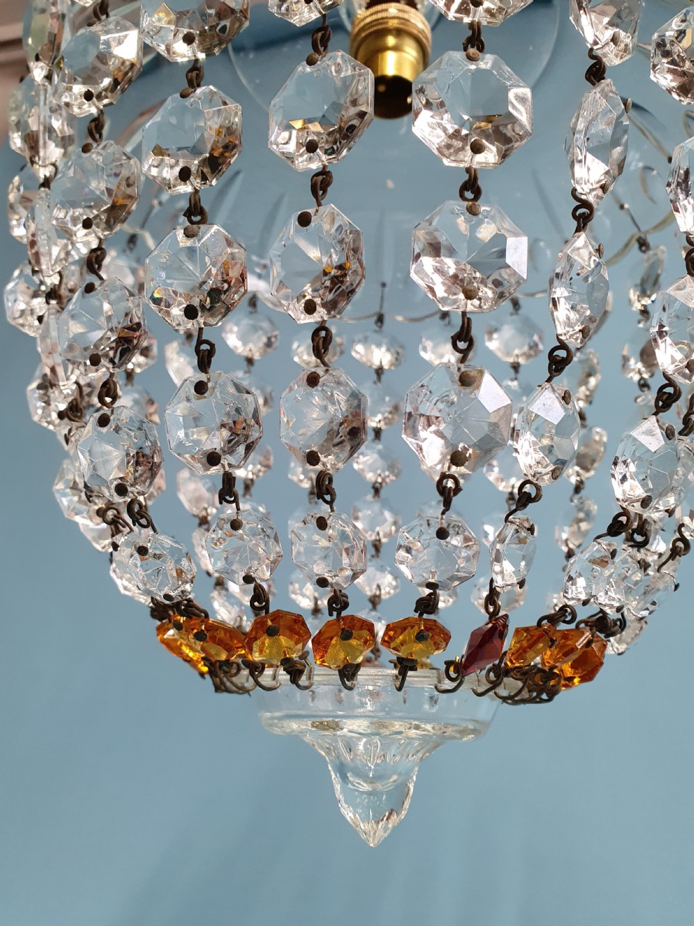 A small ceiling light with a clear glass dome top and cascading strands of faceted glass beads forming a tapered pendant shape. View VI