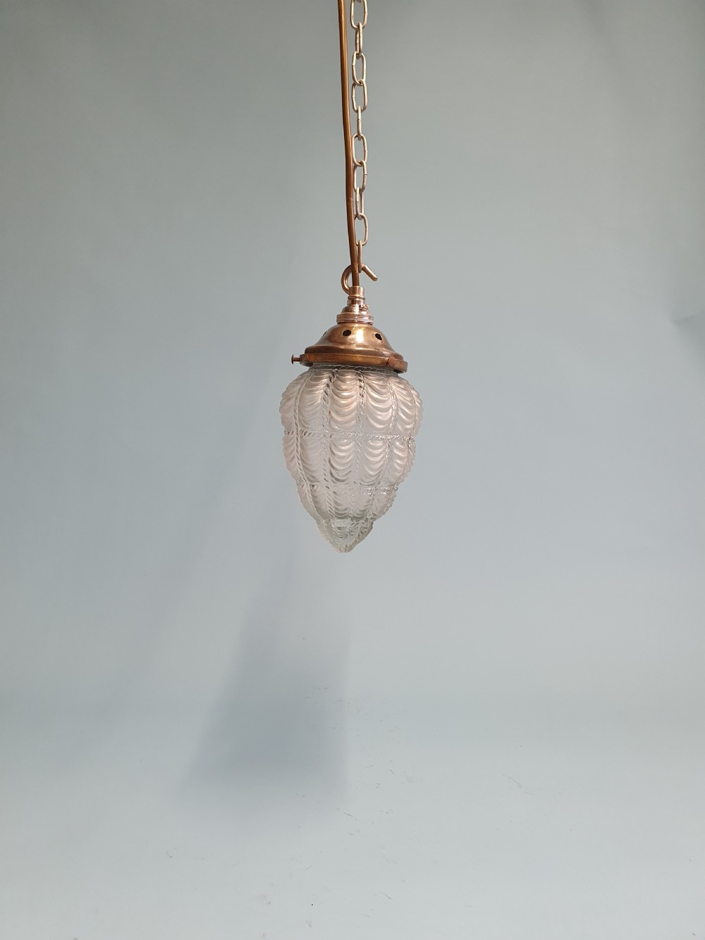 Early 20th century moulded glass and brass pendant