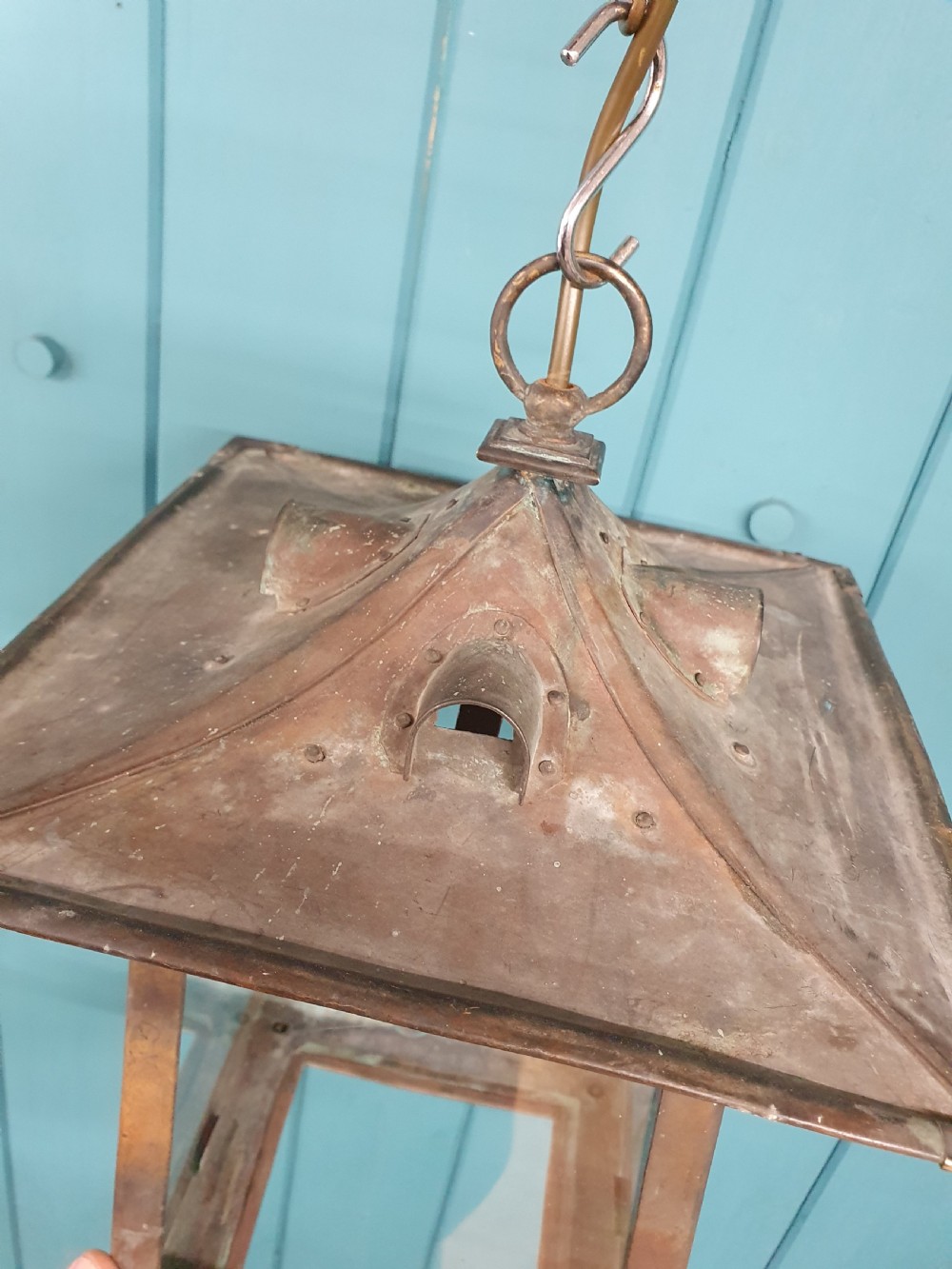 An early 20th-century patinated brass pendant lantern with clear glass side panels suspended by a chain. View VII