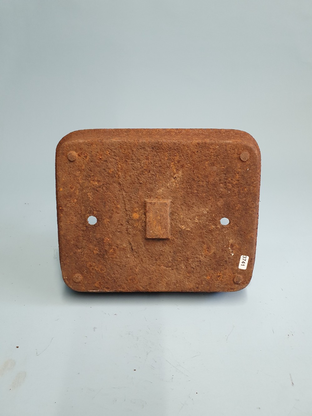 A late nineteenth-century cast iron boot scraper featuring a rectangular drip tray base and a scroll-detailed scraping blade with heavy rusted patina. View V