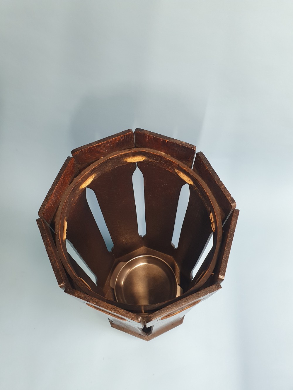 An early 20th-century dark wood octagonal stick stand featuring slatted vertical panels and an internal circular divider ring. View IV