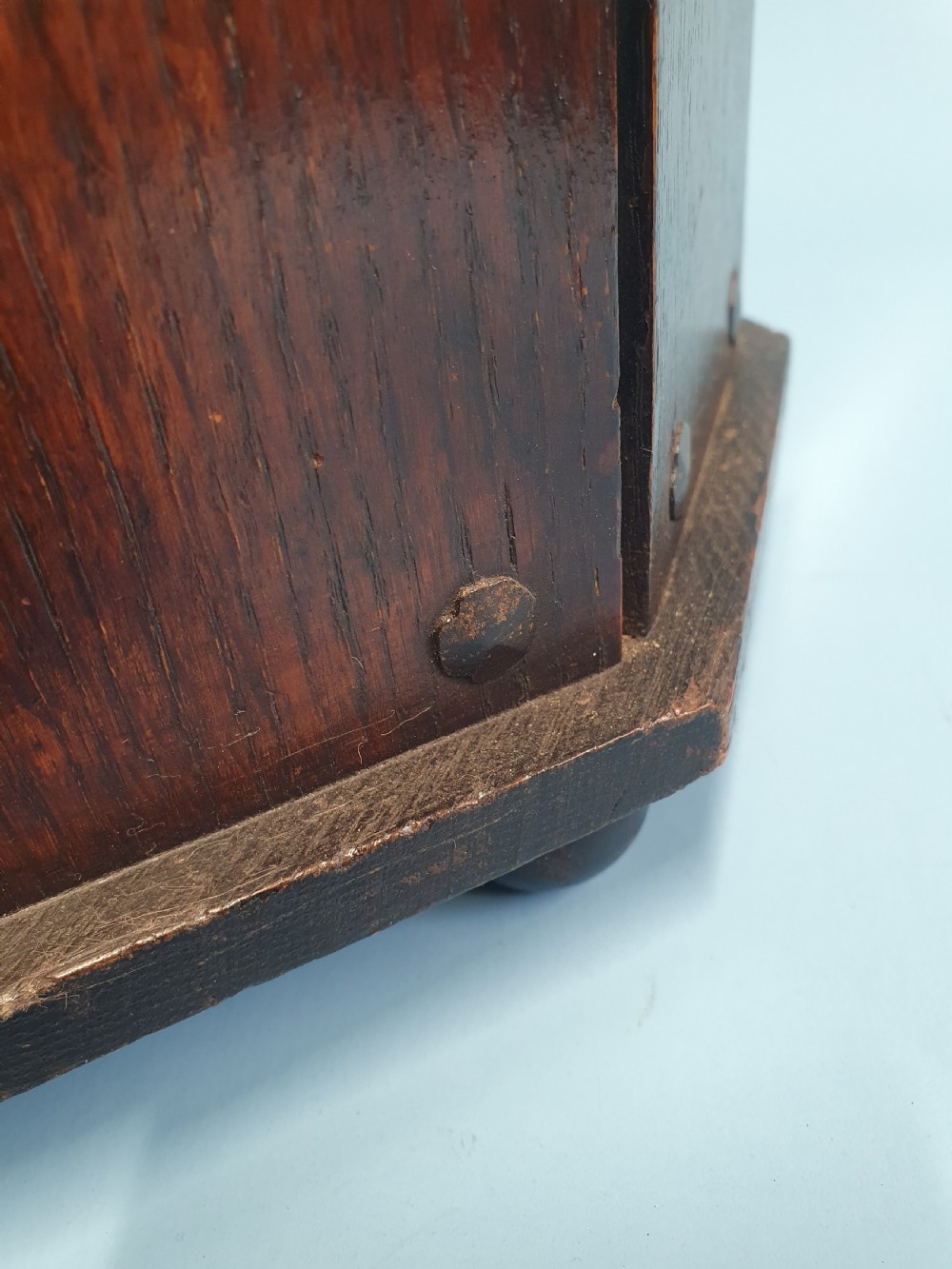 An early 20th-century dark wood octagonal stick stand featuring slatted vertical panels and an internal circular divider ring. View VI