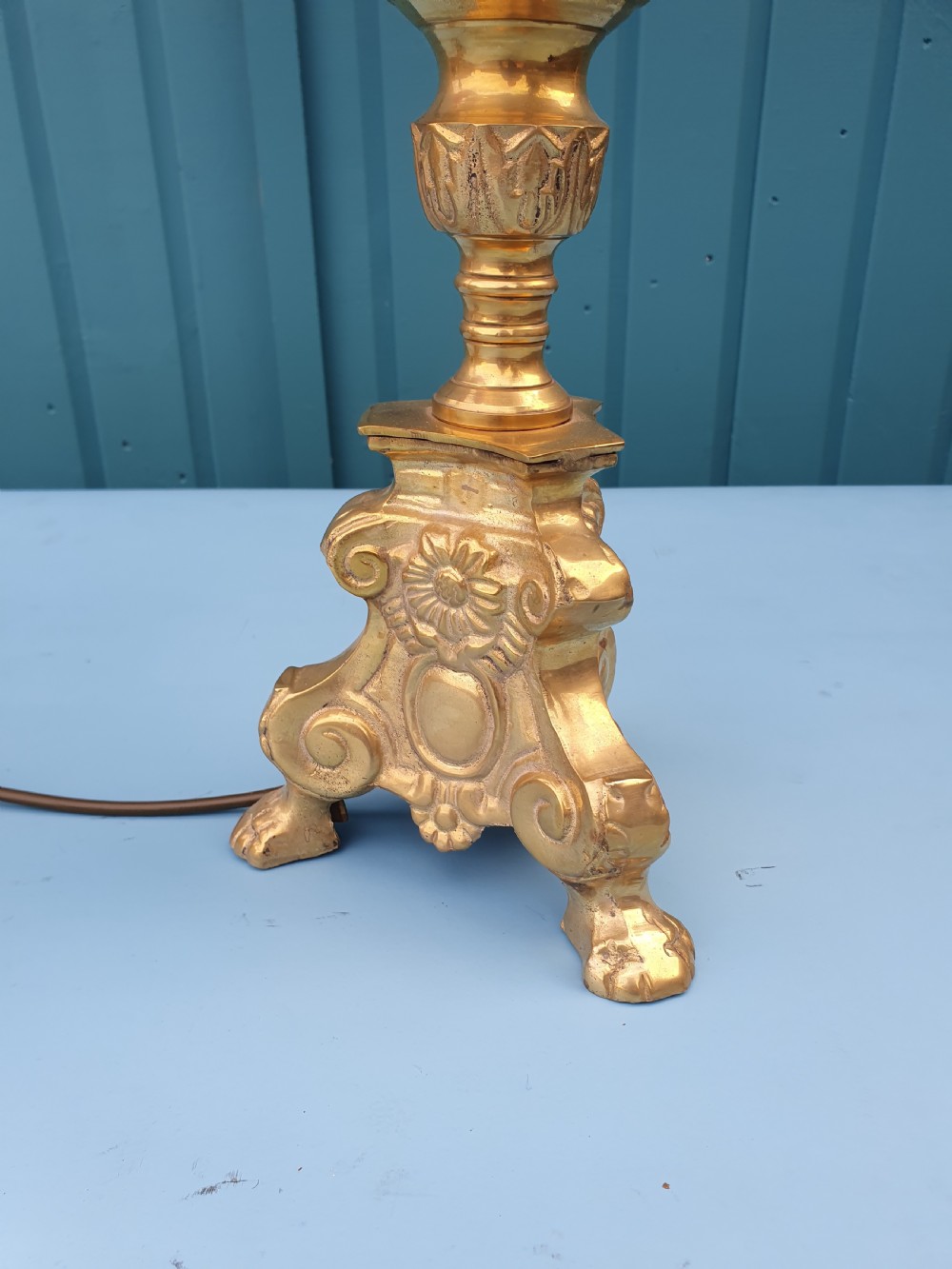 A pair of ornate cast brass candlestick-style table lamps fitted with bright pink fabric drum shades. View VI