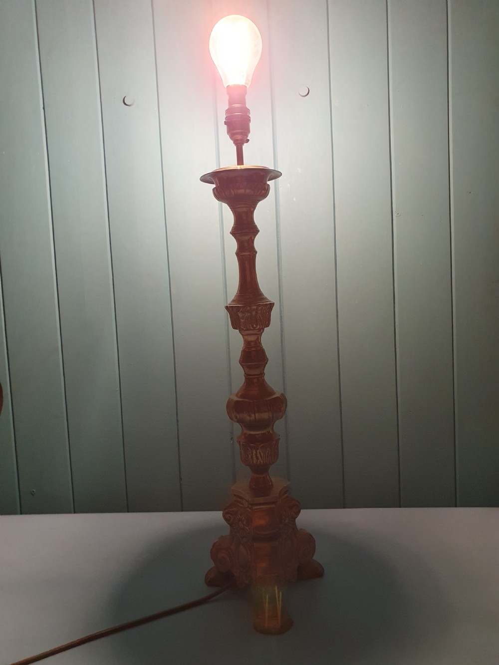 An early 20th-century Baroque revival cast brass candlestick table lamp with a scrolled tripod base and turned stem. View III