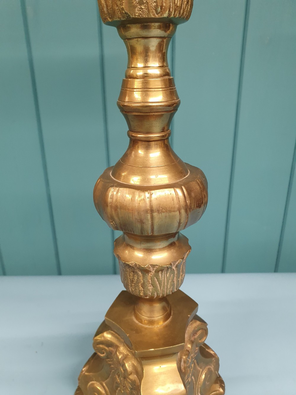 An early 20th-century Baroque revival cast brass candlestick table lamp with a scrolled tripod base and turned stem. View VI